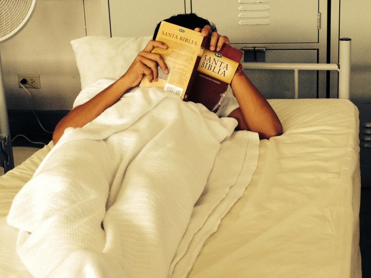 Image: A young boy reading his bible at the Joint Base San Antonio Lackland Shelter