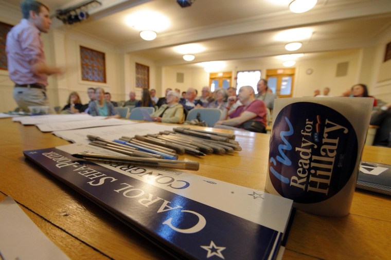 Image: Campaign stickers, including those for U.S. Representative Carol Shea Porter (D-NH), are on hand at a Manchester Democratic Summit in Manchester