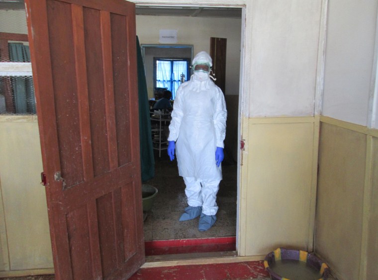 Nurse Veronica Koroma stands in the doorway of the Viral Hemorrhagic Fever (VHF)  ward at Kenema Government Hospital in Sierra Leone.