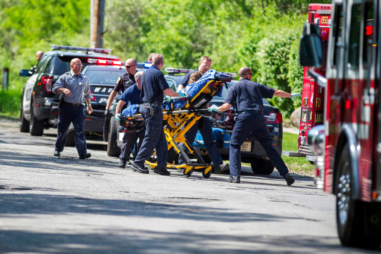 Image: Rescue workers take a stabbing victim to the ambulance in Waukesha, Wis.