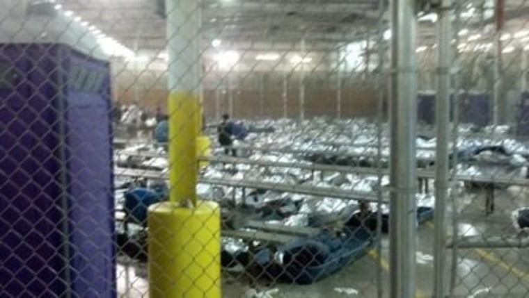 Image: Children resting under foil blankets at a Border Patrol facility in Nogales, Ariz.