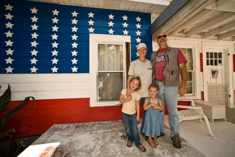 Image: Greer and his wife stand with daughters on the front porch of their 110-year-old house in Bradenton