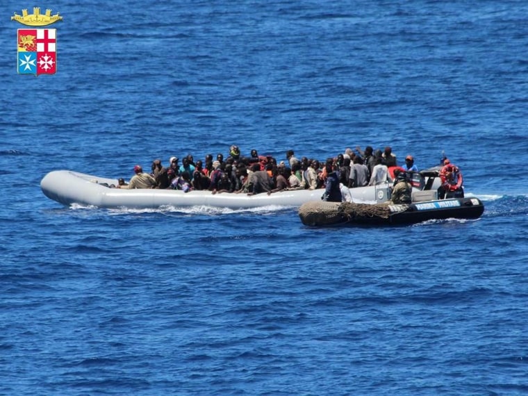 Image: Migrants on boats being intercepted by the Italian army off the coast of Sicily on June 6, 2014.