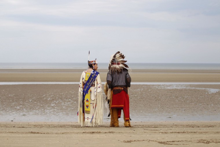 Image: Descendants of Comanche indian soldiers prays on Utah Beach