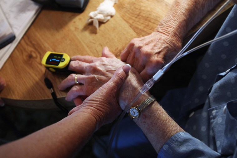 Image: Registered nurse Susan Eager pays a house call visit to a patient on March 26, 2012 in Denver, Colo.