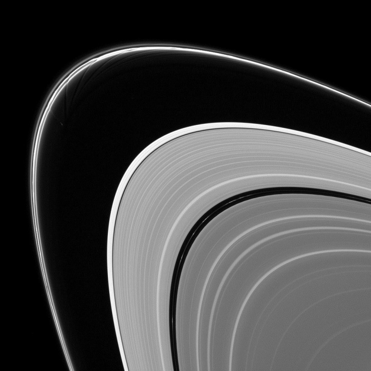 This view from the Cassini orbiter highlights delicate streamers and channels sculpted by the moon Prometheus as it interacts with Saturn's outer F ring.