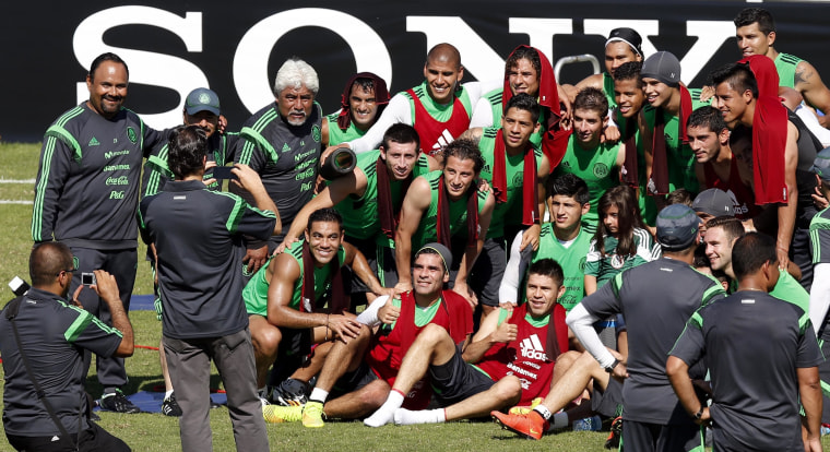 Image: Mexico's national soccer team pose for a photograph after their training session in Santos