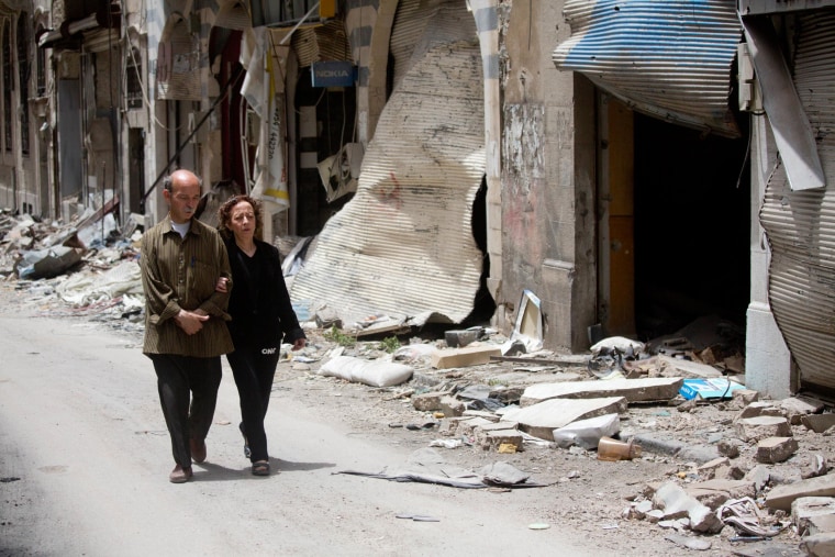 Image: Zeinat Akhras and her brother Ayman walk to from home to a church in Homs
