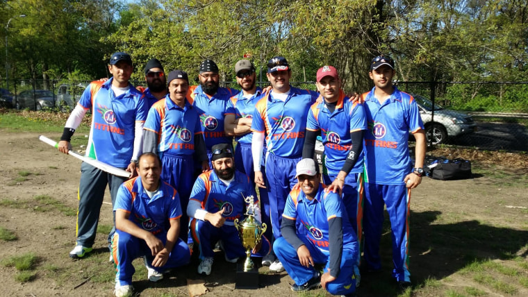 Ajith Bhaskar Shetty (standing, third from right) poses with his cricket teammates.