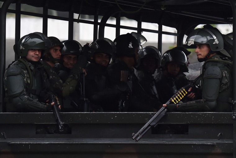 Image: Members of the Brazilian army are seen as they leave after escorting the England football team to their hotel in Rio de Janeiro