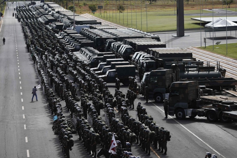 Image: Members of Brazilian Army, Navy and Air Force attend presentation of Defence and Security personnel and equipment that will be used during the 2014 World Cup in Brasilia