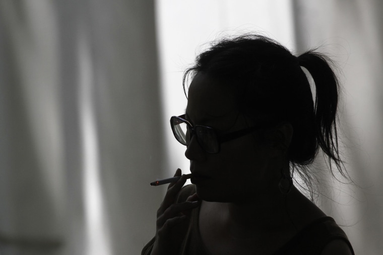 Image: A woman smokes a cigarette in Los Angeles, Calif. on May 31, 2012.