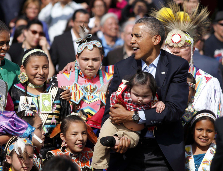 Image: U.S. President Obama holds a baby at Cannon Ball Flag Day Celebration in Standing Rock Sioux Reservation in North Dakota