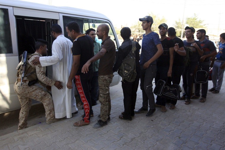 Image: Volunteers, who have joined the Iraqi army to fight against the predominantly Sunni militants from the radical Islamic State of Iraq and the Levant (ISIL) who have taken over Mosul and other northern provinces, prepare to board a bus in Kerbala