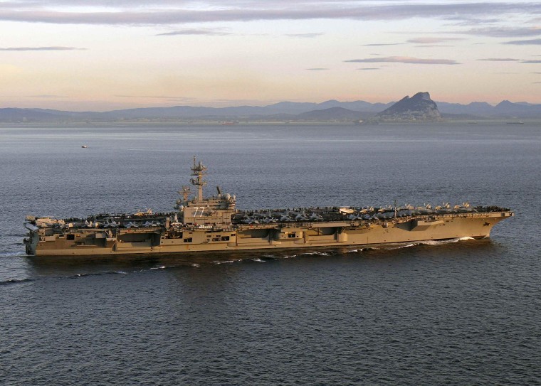 Image: Handout photo of aircraft carrier USS George H.W. Bush transiting the Strait of Gibraltar into the Mediterranean Sea