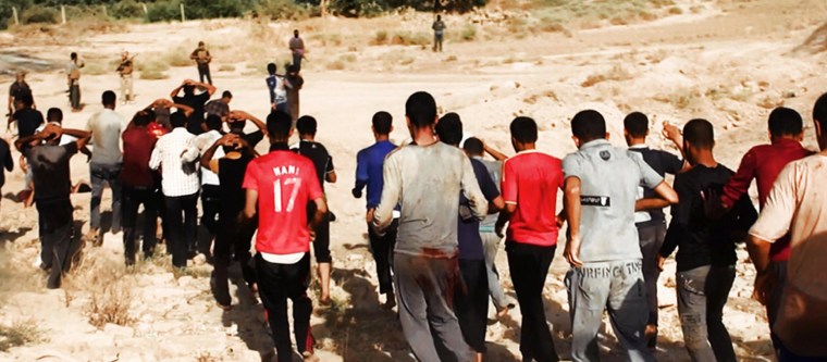 Image: Militants from ISIL lead captured Iraqi soldiers wearing plain clothes to an open field moments before shooting them in Tikrit.