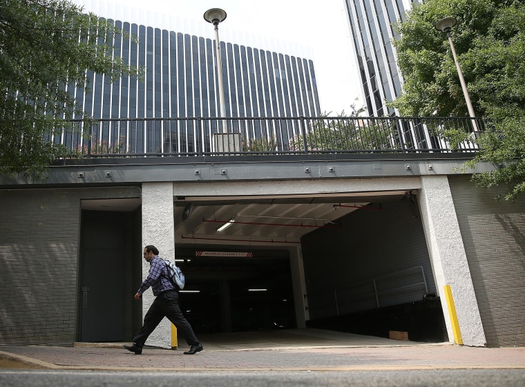 Image: A man walks past the entrance of the parking garage where Washington Post reporter Bob Woodward held late night meetings with Deep Throat