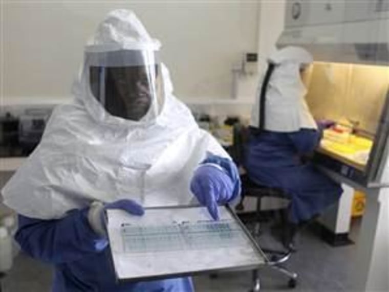 A technician in Entebbe points to Ebola virus. A new surveillance program may help catch these threats, CDC says.