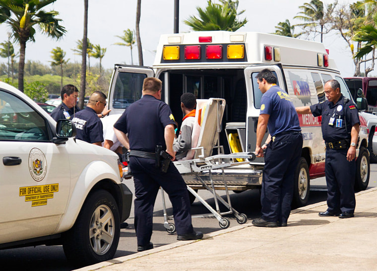 Image: A 16-year-old boy, seen sitting on a stretcher center, stowed away in the wheel well of a flight from San Jose, Calif., to Maui