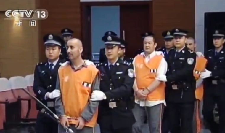 Image:  Prisoners are escorted into the Intermediate People's Court