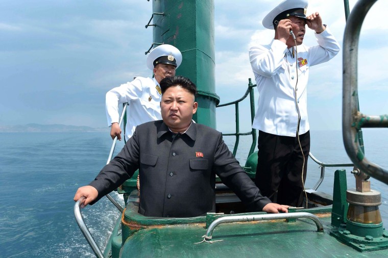 Image: North Korean leader Kim Jong Un stands on the conning tower of a submarine during his inspection of the KPA Naval Unit 167