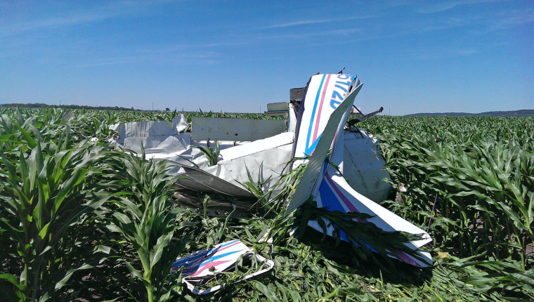 Image: The wreckage of the Cessna 182 skydiving plane that Shawn Kinmartin was flying rests in a cornfield Saturday