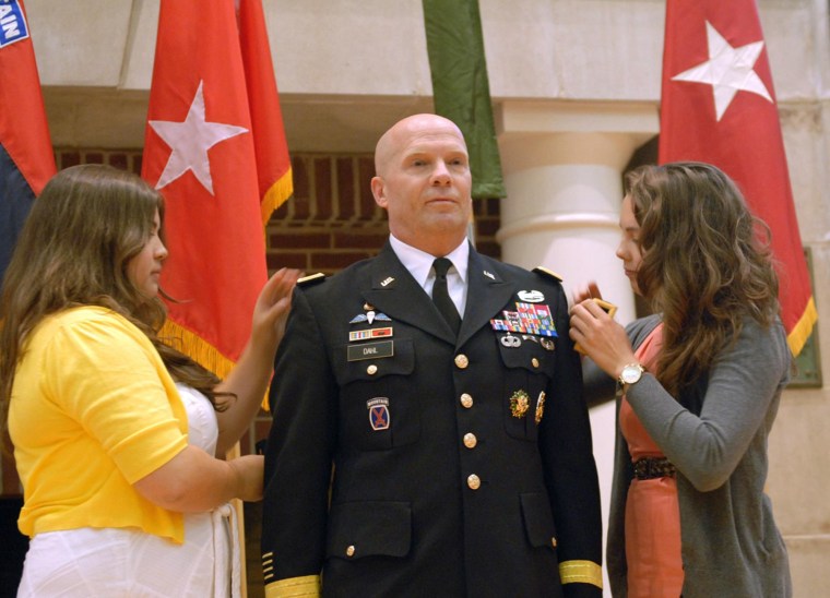 Allie Dahl and Madeline Dahl place new two-star rank on the shoulders of their father, Maj. Gen. Kenneth R. Dahl, during his promotion ceremony in June 2012 at the U.S. Military Academy at West Point.