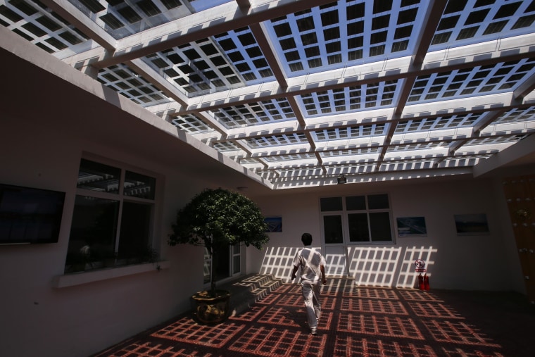 Image: A man walks inside an office building of Yingli Solar in Baoding