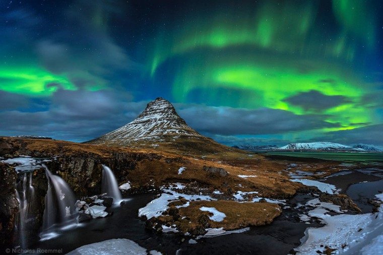 "Kikjufell Nights" by Nicholas Roemmelt. Aurora over Kirkjufell waterfalls in Iceland. The third winner in Beauty of the Night category. 
