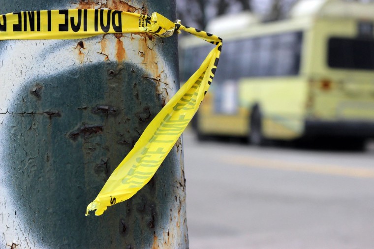 Image: Police tape is wrapped around a pole near the shooting scene where an RTA bus driver was attacked and shot in Dayton, Ohio