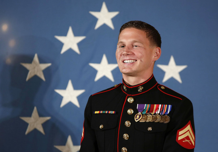 Image: Retired U.S. Marine Corps Corporal Carpenter stands before receiving the Medal of Honor from Obama during a ceremony in the East Room of the White House in Washington