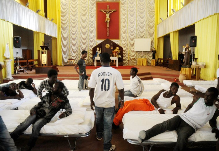 Image: Migrants from Africa are temporarily sheltered in the Catholic church of  St. Curato D'Ars in Palermo, Sicily