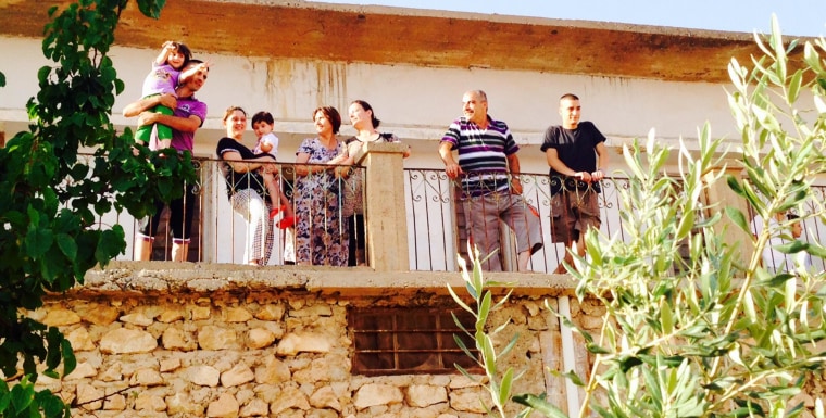 Image: Leith Rahima and his family stand in Al-Qosh, an Assyrian Christian town in northern Iraq.