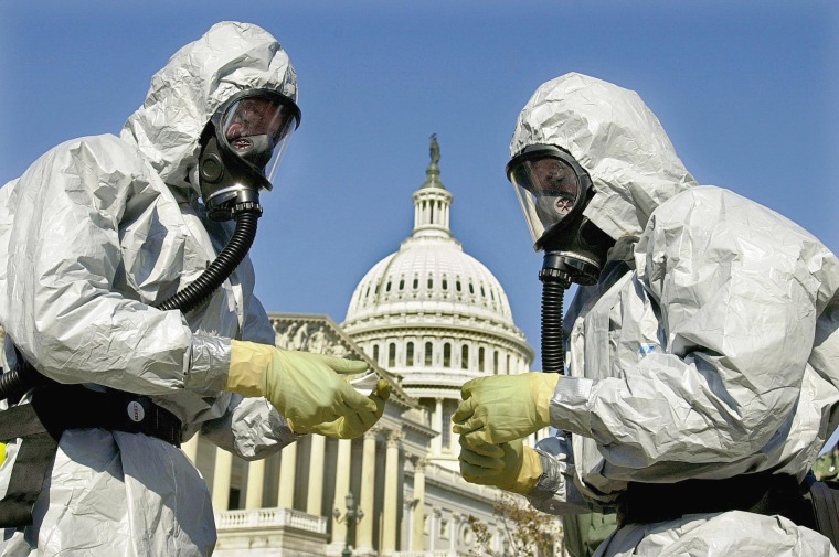 Members of the U.S. Marine Corps' Chemical-Biological Incident Response Force demonstrate anthrax clean-up techniques during a news conference in on Capitol Hill in Washington.  