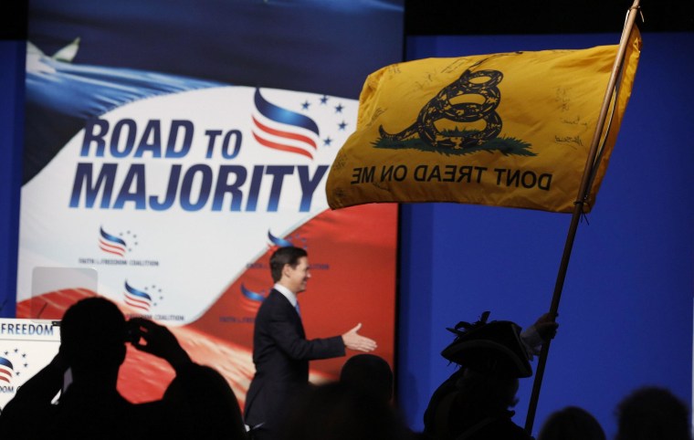 Image: William Temple, from the Golden Isles Tea Party, waves a flag in the audience at the 5th annual Faith & Freedom Coalition's "Road to Majority" Policy Conference in Washington