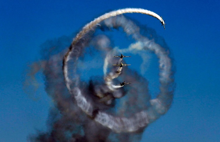 Image: Aerobatic Yakkers team perform on YAK-52 airplanes during Bucharest International Air Show at Baneasa airport