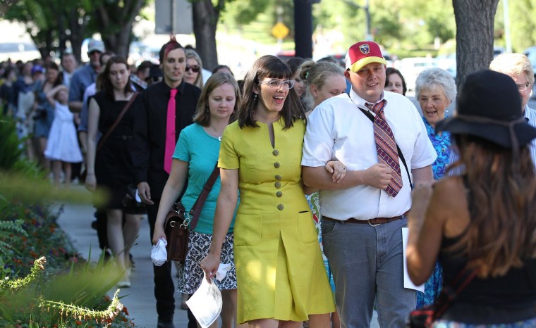 Image: Kate Kelly, center, walks with supporters to the Church Office Building of the Church of Jesus Christ of Latter-day Saints during a vigil