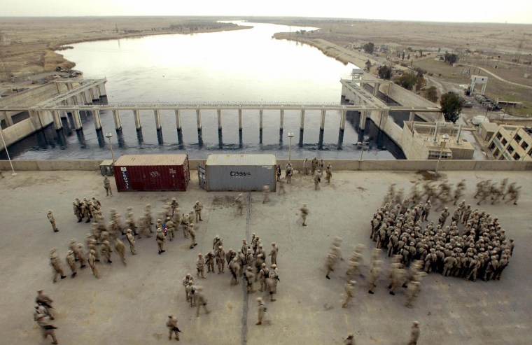 Image: U.S. Marines from the first Battalion 23rd Marines gather in the Haditha's dam deck 250 kms northwest from Baghdad on Feb. 19, 2005. 