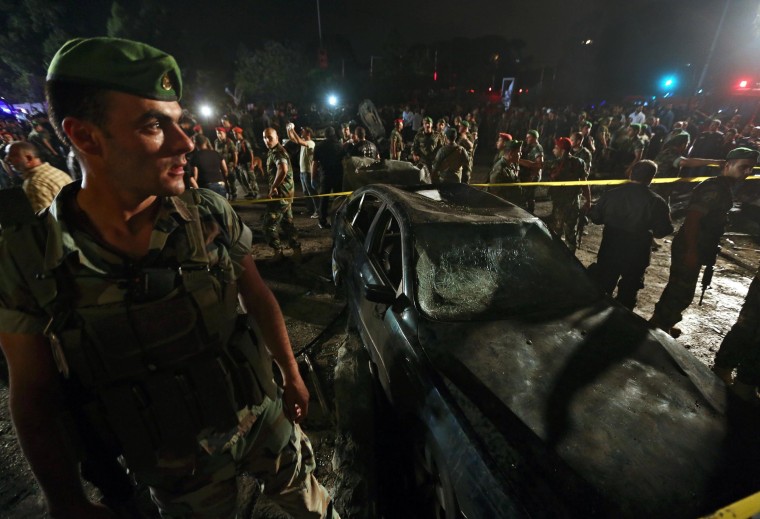Image: Lebanese army and citizens gather at the site of a car bombing in a southern suburb of Beirut