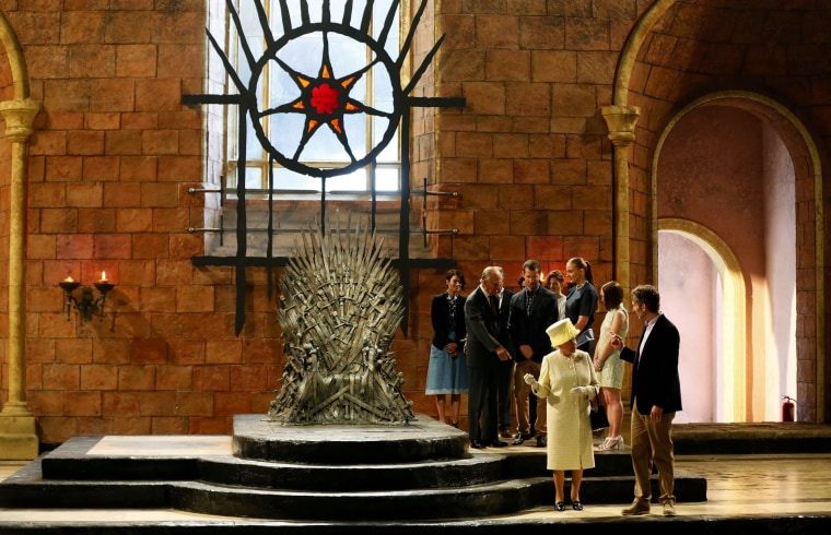 Image: Britain's Queen Elizabeth and Prince Philip talk with members of the cast on the set of the television show Game of Thrones in the Titanic Quarter of Belfast