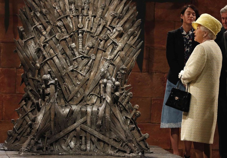 Image: Britain's Queen Elizabeth looks at the Iron Throne as she meets members of the cast on the set of the television show Game of Thrones in the Titanic Quarter of Belfast