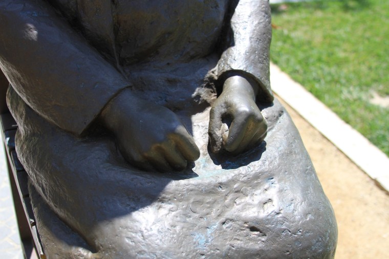 According to the Comfort Women memorial, the tight fists represent the girl's firm resolve for a deliverance of justice.