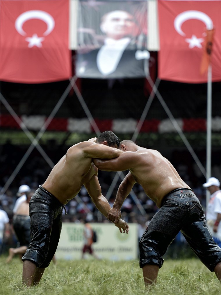 Image: Two wrestlers, or \"pehlivans\" as in Turkish, in action during the traditional Kirkpinar Oil wrestling festival in Edirne, Turkey, June 20.