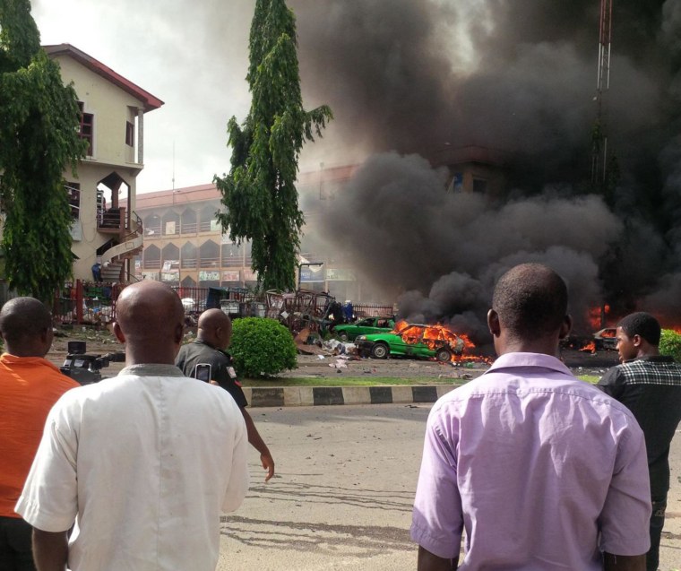 Image: People watch as smoke fills the sky, after an explosion, at a shopping mall on June 25, in Abuja, Nigeria