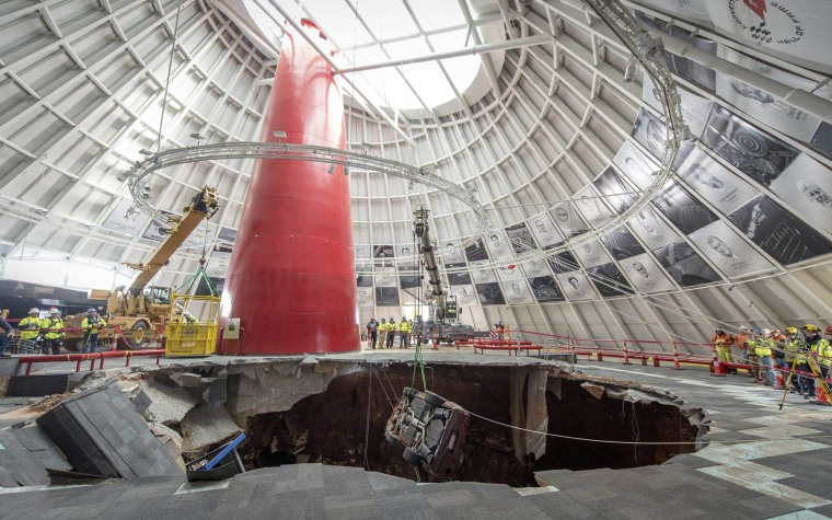 Image: Workers use a crane to extract the 1993 40th Anniversary Chevrolet Corvette from the sinkhole at the National Corvette Museum in Kentucky