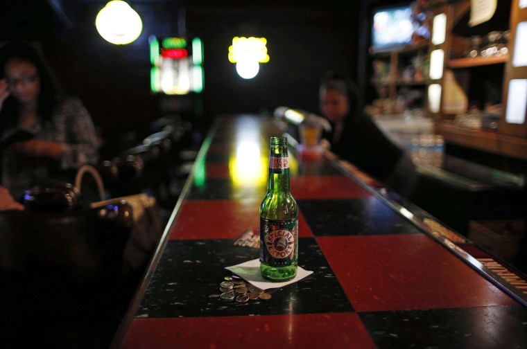 Image: An empty beer bottle is seen on the bar at the Checkerboard Lounge in Chicago