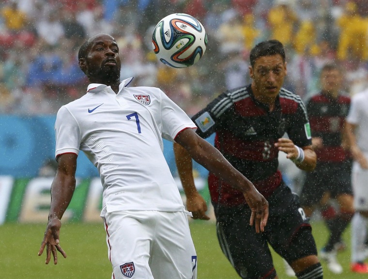 Image: Beasley of the U.S. fights for the ball with Germany's Ozil during their 2014 World Cup Group G soccer match at the Pernambuco arena in Recife