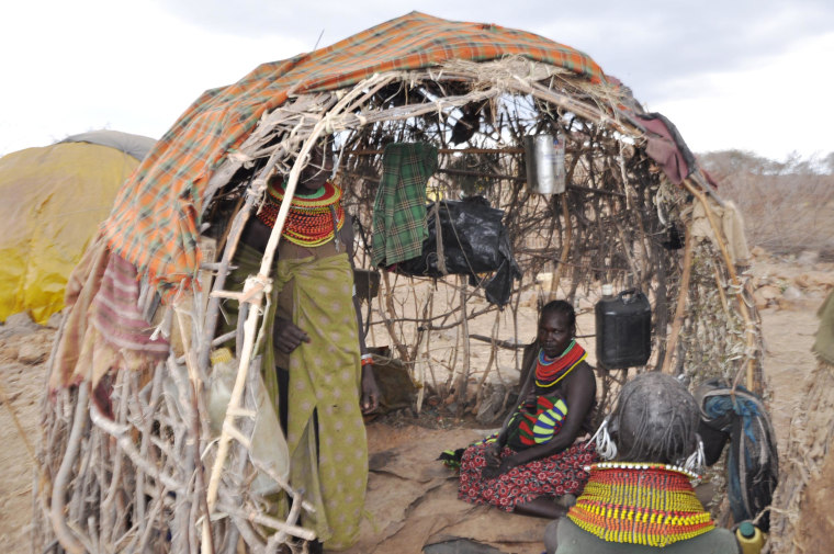 Image: These women of Marti village inside the manyatta are discussing the drought's devastation, Turkana in northern Kenya