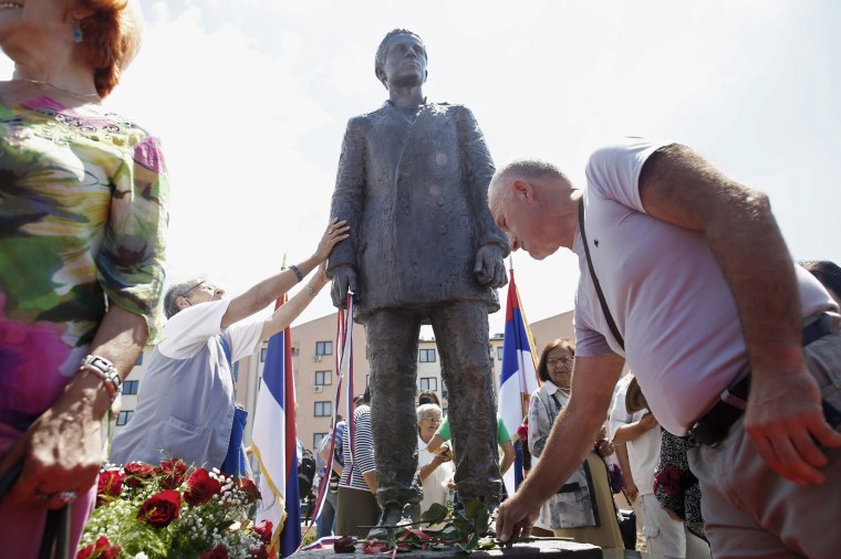 Image: Bosnian Serbs lay flowers after the unvieling of a statue of Gavrilo Princip after an opening ceremony in East Sarajevo
