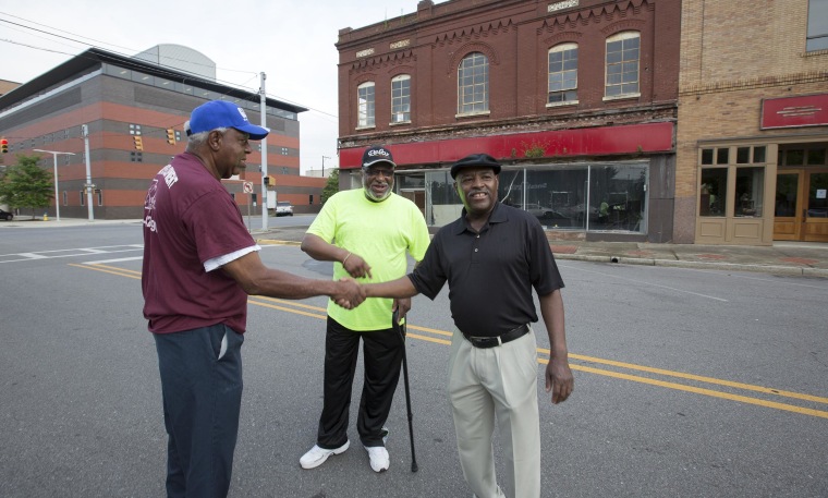 Herman Williams, Albert Shade and Desmond Wright  stand outside of the now-closed McLellan's department store almost 50 years after they staged a sit-in there at the whites-only lunch counter.